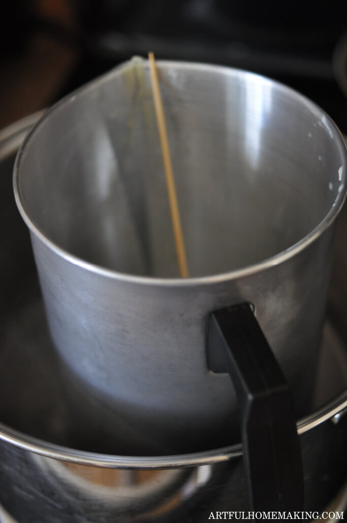 saucepan with candle melting pitcher and bamboo skewer