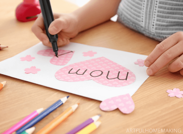 child making a card for mom