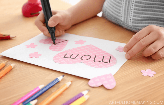 child making a card for mom