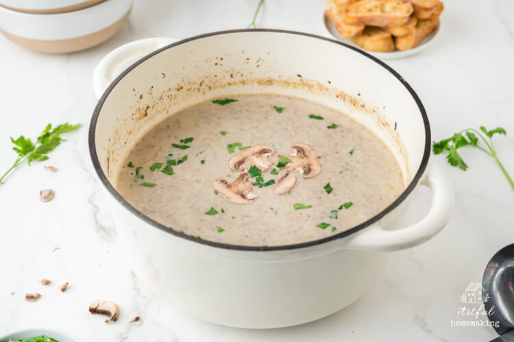 a white Dutch oven filled with homemade mushroom soup
