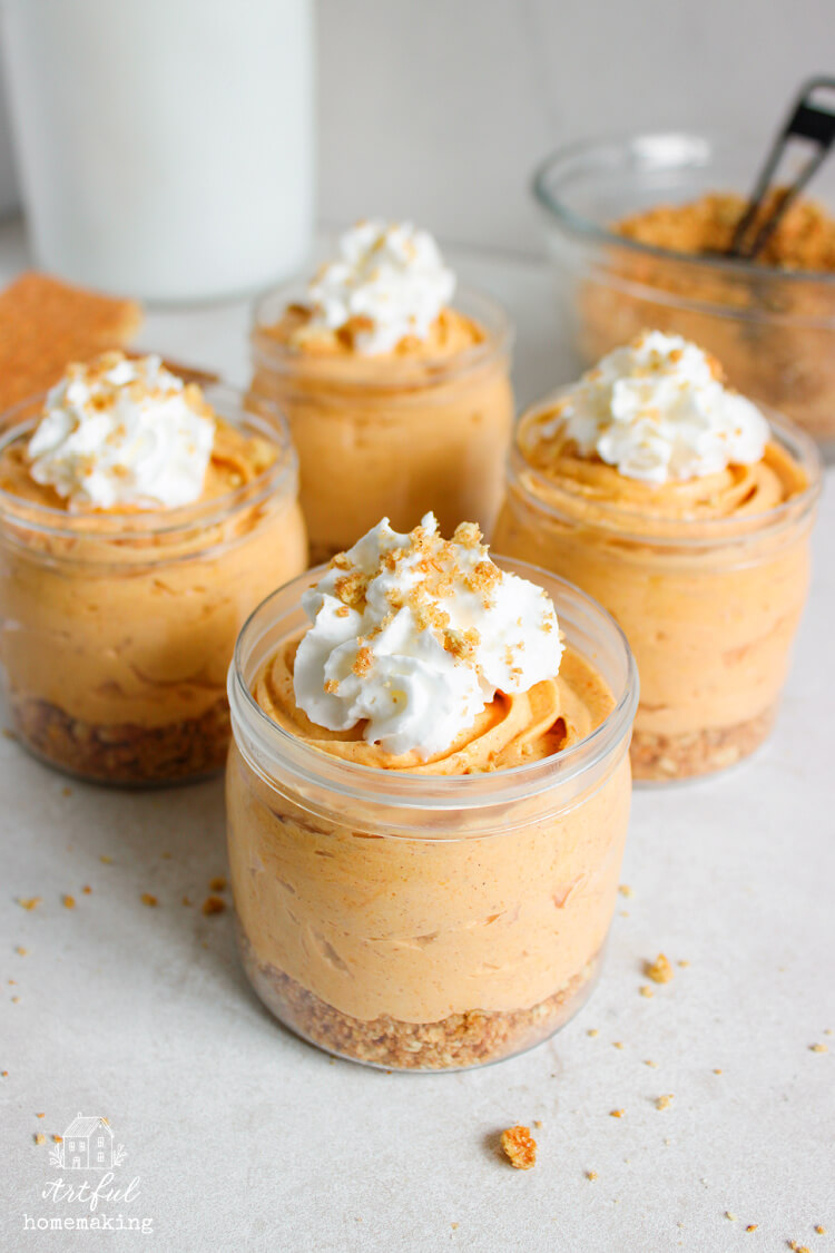 four no-bake pumpkin cheesecake cups on a counter 