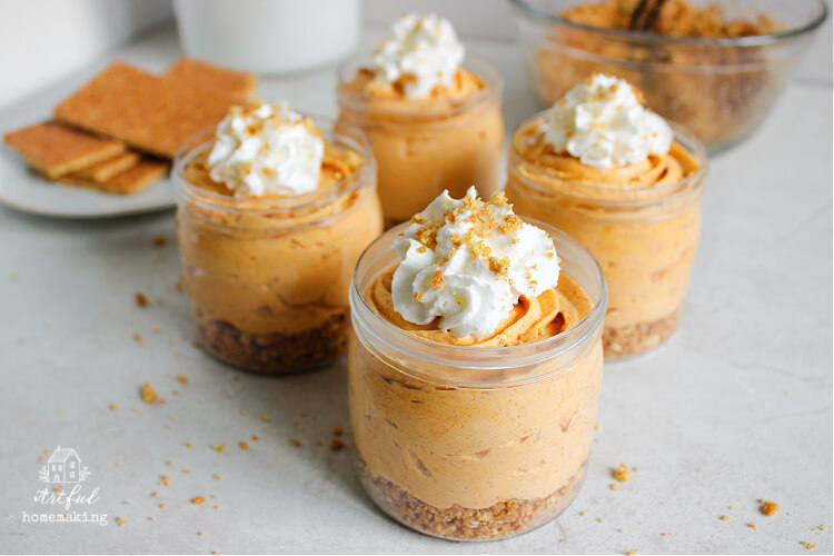 no bake pumpkin cheesecakes in cups on a counter
