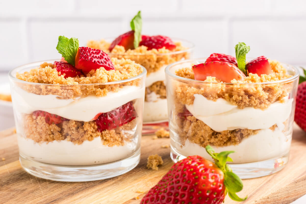 side view of three strawberry cheesecake cups