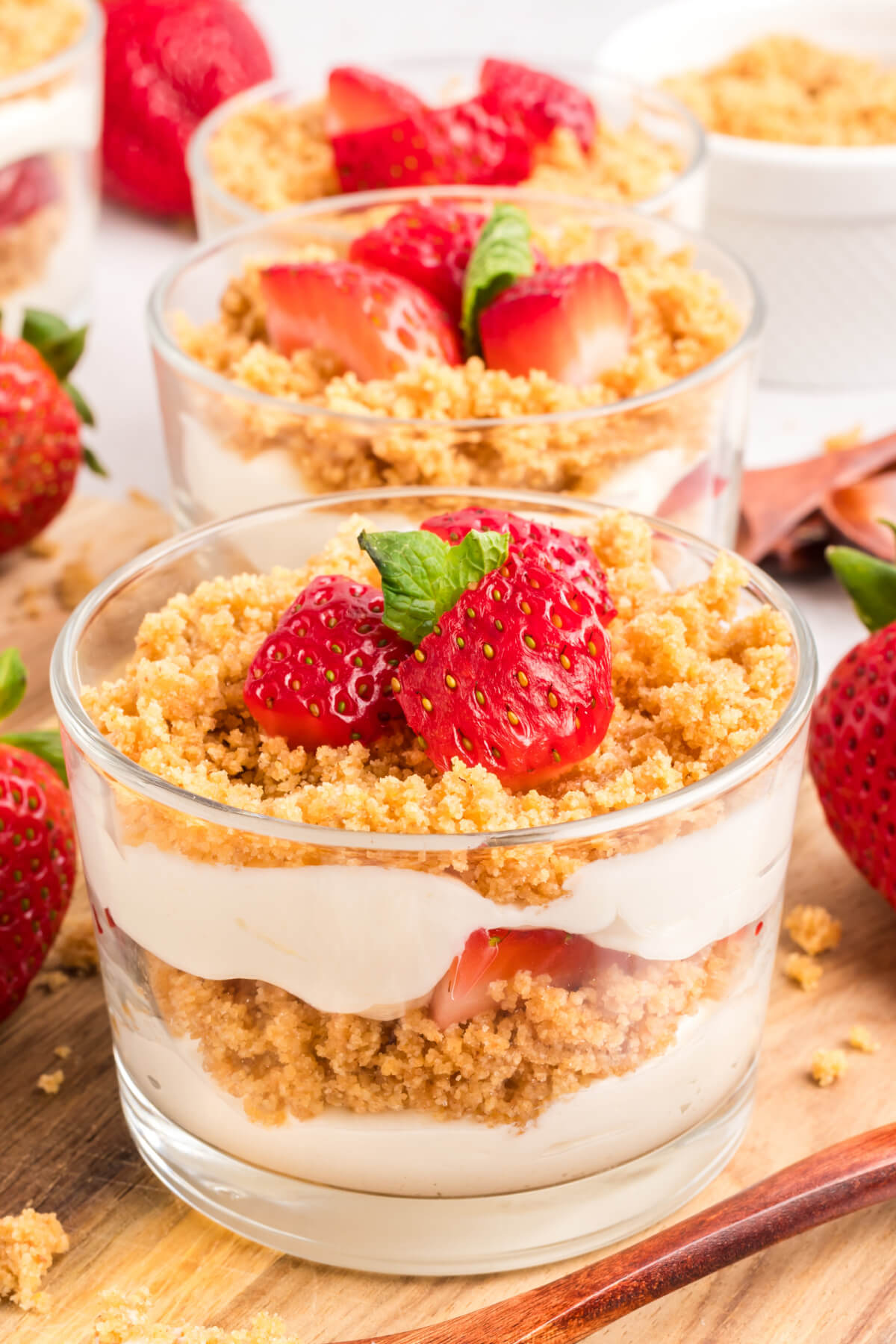 glass cups filled with no bake strawberry cheesecake