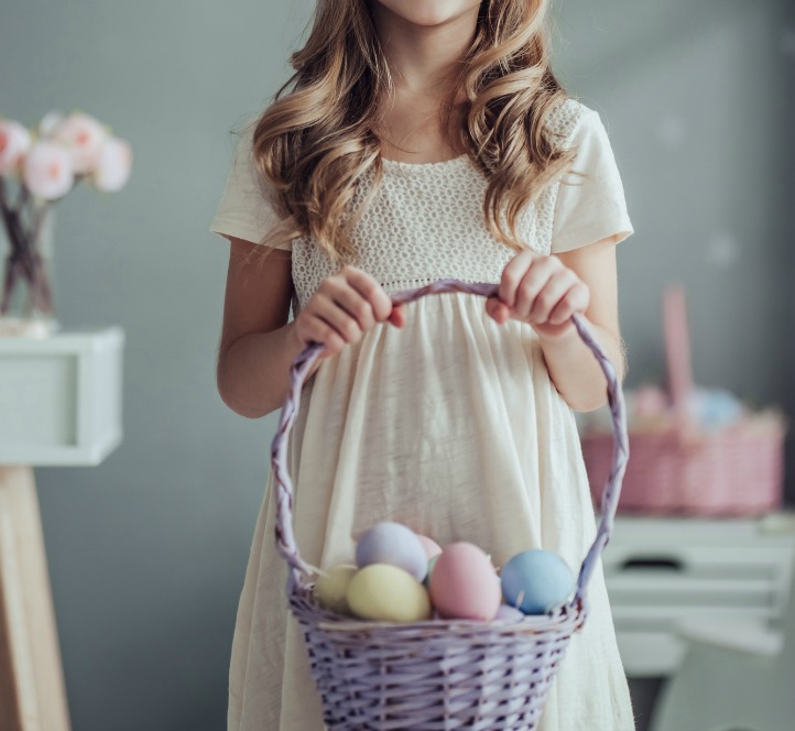 girl with Easter basket containing non-candy Easter egg fillers