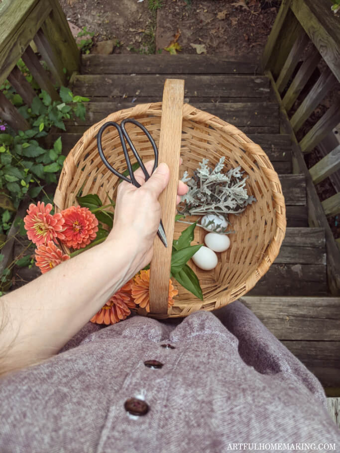 woman holding basket with eggs and flowers