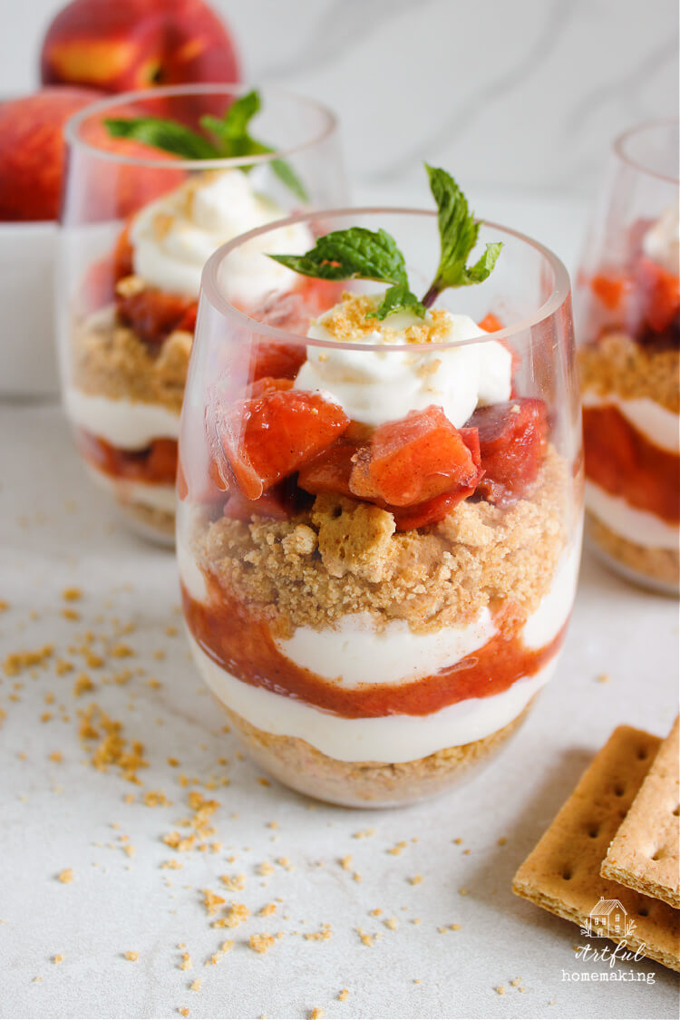 peaches and cream parfait in a glass on a countertop