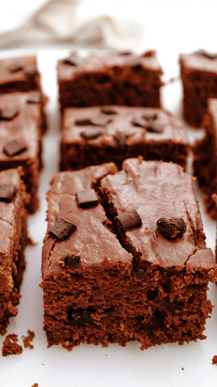 pumpkin chocolate brownies in a row on a cutting board