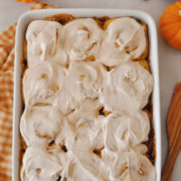 sourdough pumpkin cinnamon rolls in white baking dish