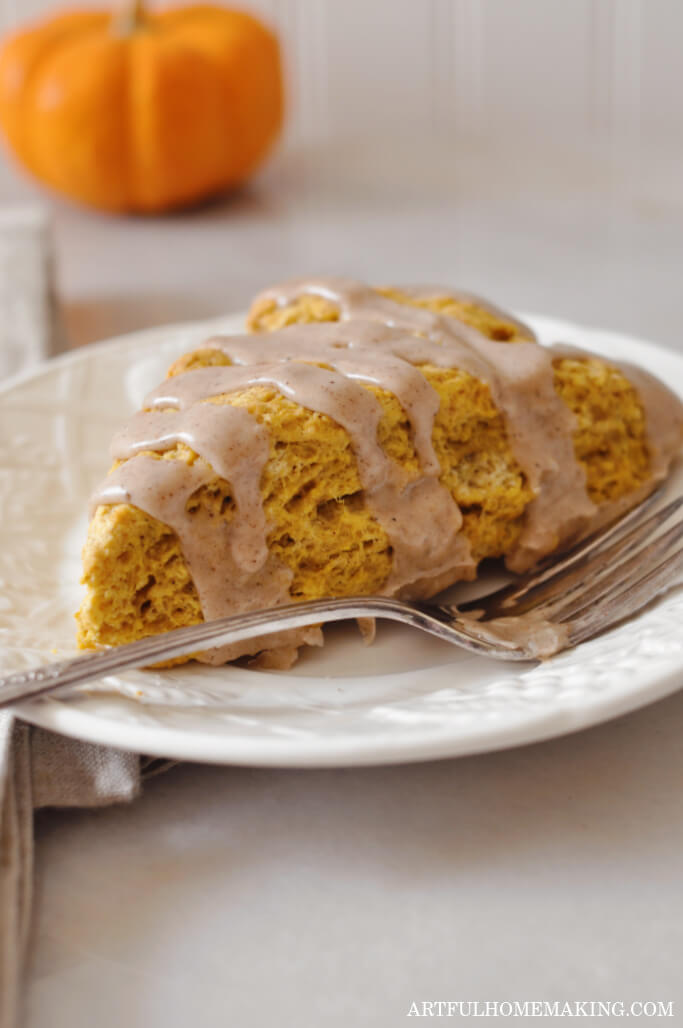 pumpkin scone on a white plate with fork