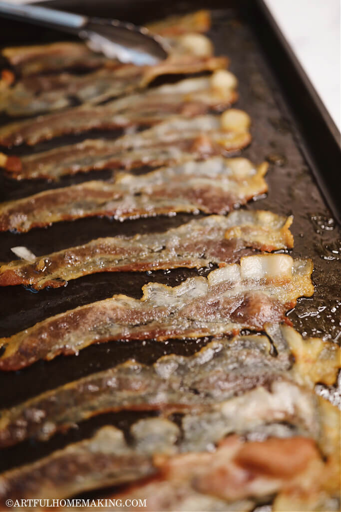 baked bacon on a metal cookie sheet after being baked in the oven