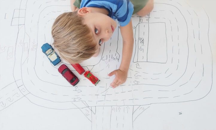 boy playing with cars rainy day