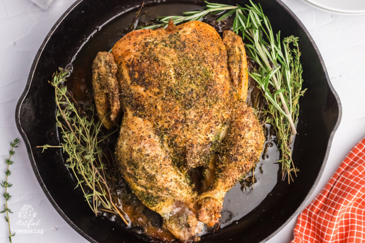 roast chicken with herbs in a cast iron skillet