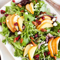 roasted pear salad with lemon vinaigrette on a white salad platter