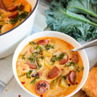 sausage potato kale soup in a white bowl