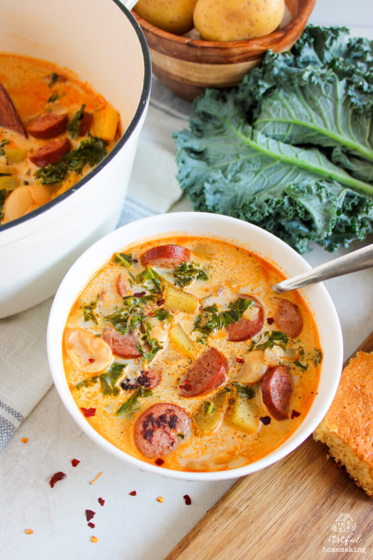 sausage potato kale soup in a white bowl