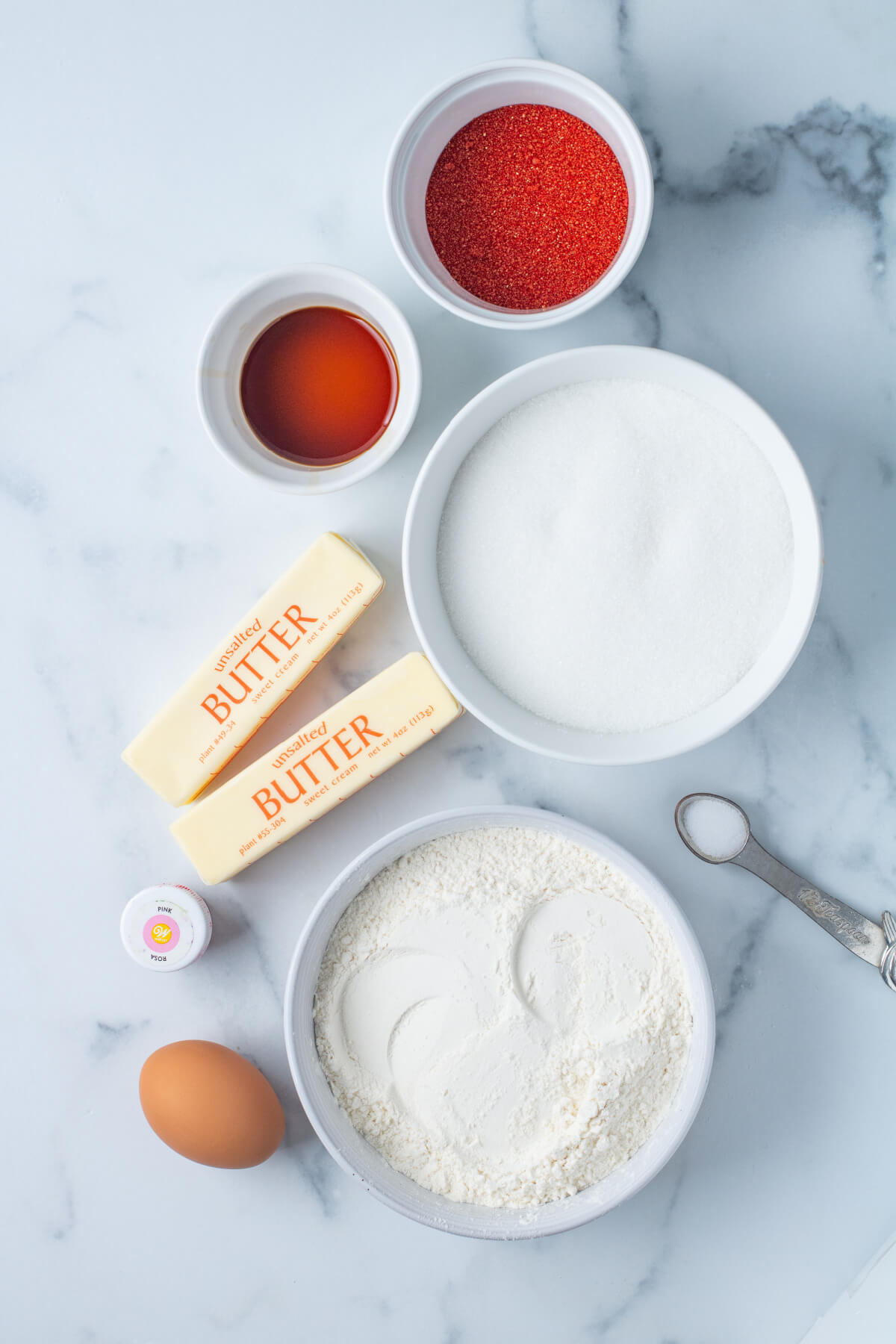 top down view of ingredients in small white bowls on marble countertop