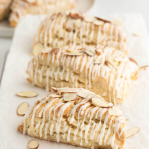top down view of three sourdough vanilla almond scones on a piece of white parchment paper