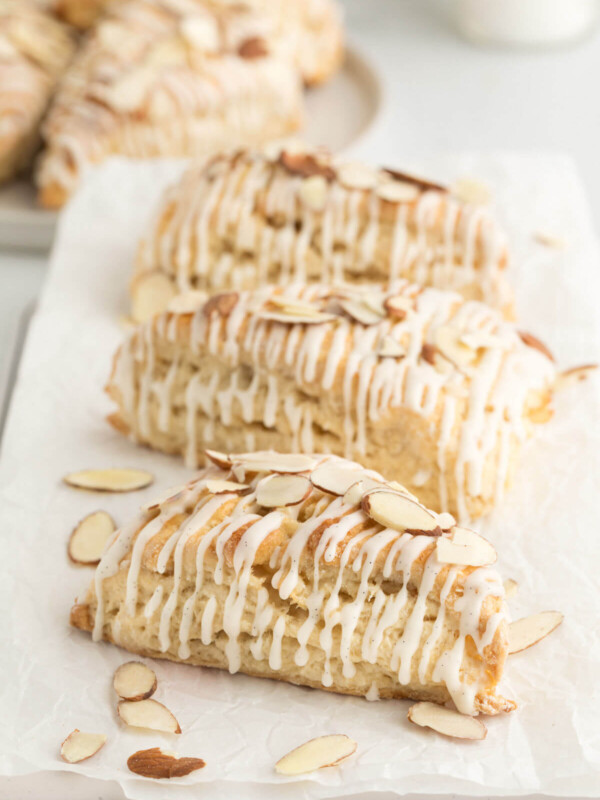 top down view of three sourdough vanilla almond scones on a piece of white parchment paper