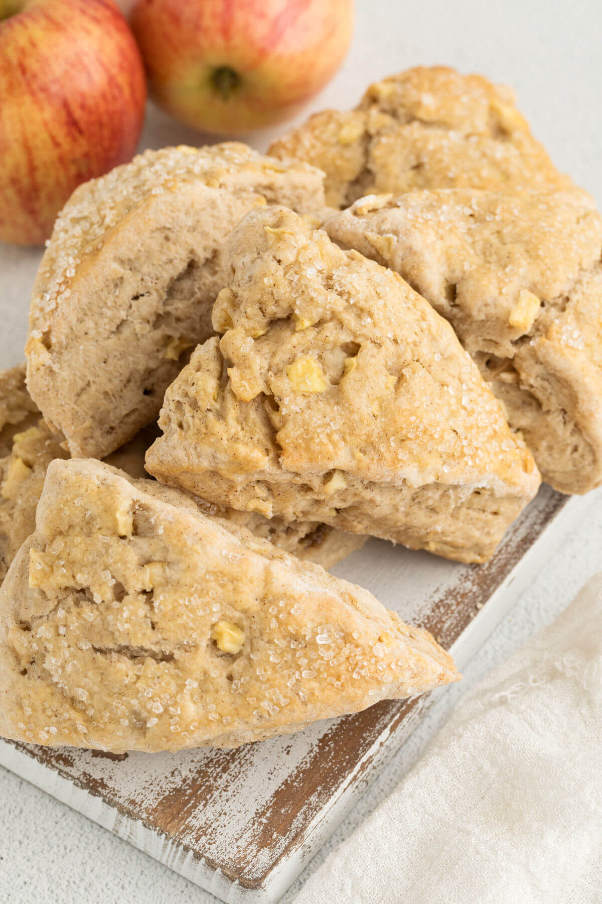 Sourdough apple cinnamon scones on a white board.