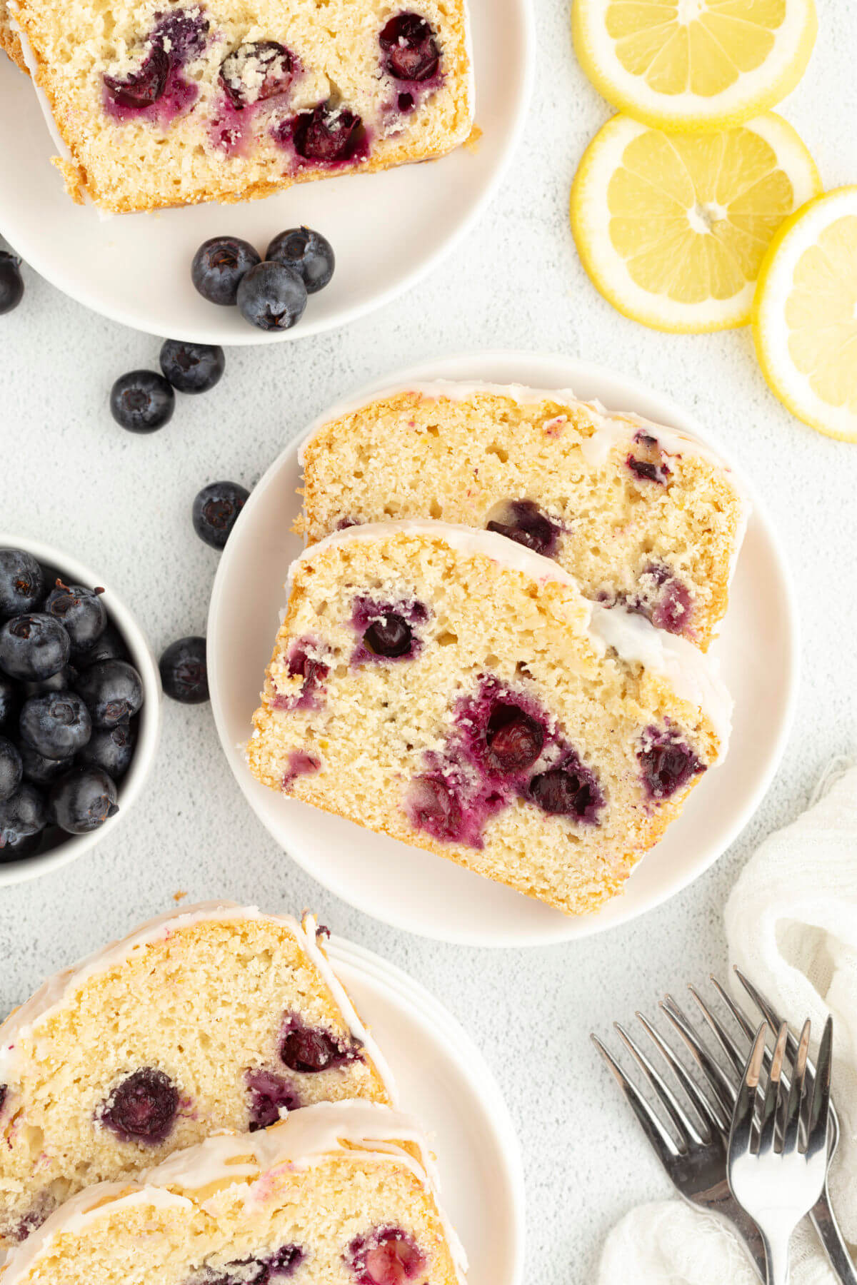 Sourdough blueberry bread cut into slices on plates.
