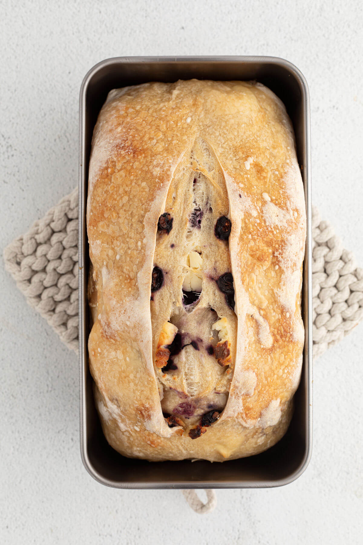 top down view of sourdough blueberry cream cheese bread in loaf pan