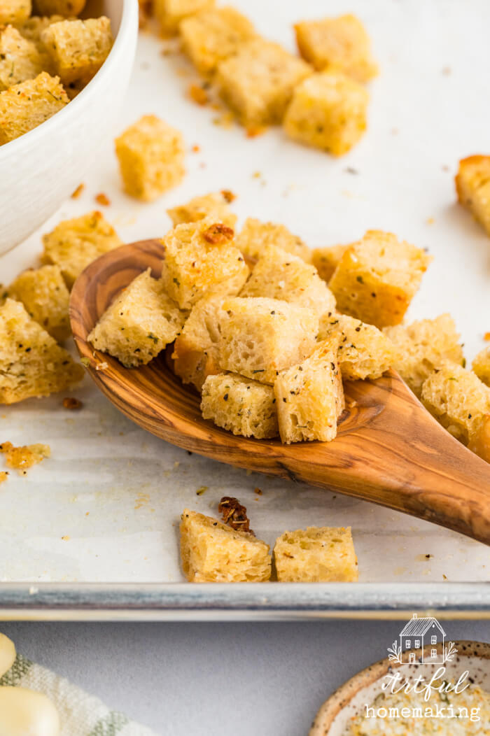 sourdough croutons on a wooden spoon