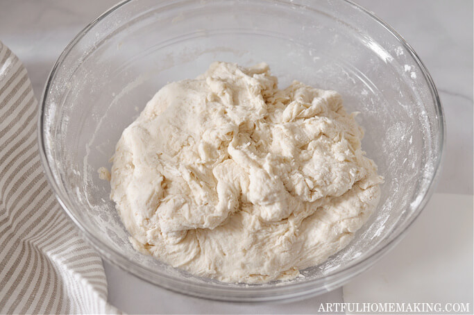 photo shows dough resting in glass bowl after being mixed