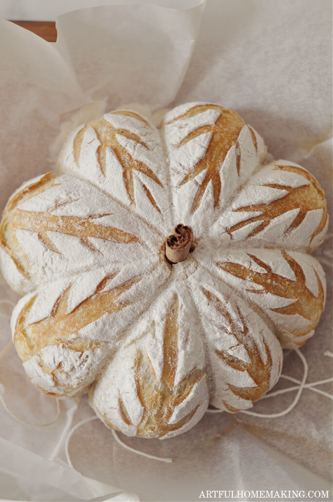 pumpkin shaped sourdough bread loaf with cinnamon stick inserted in top for pumpkin stem