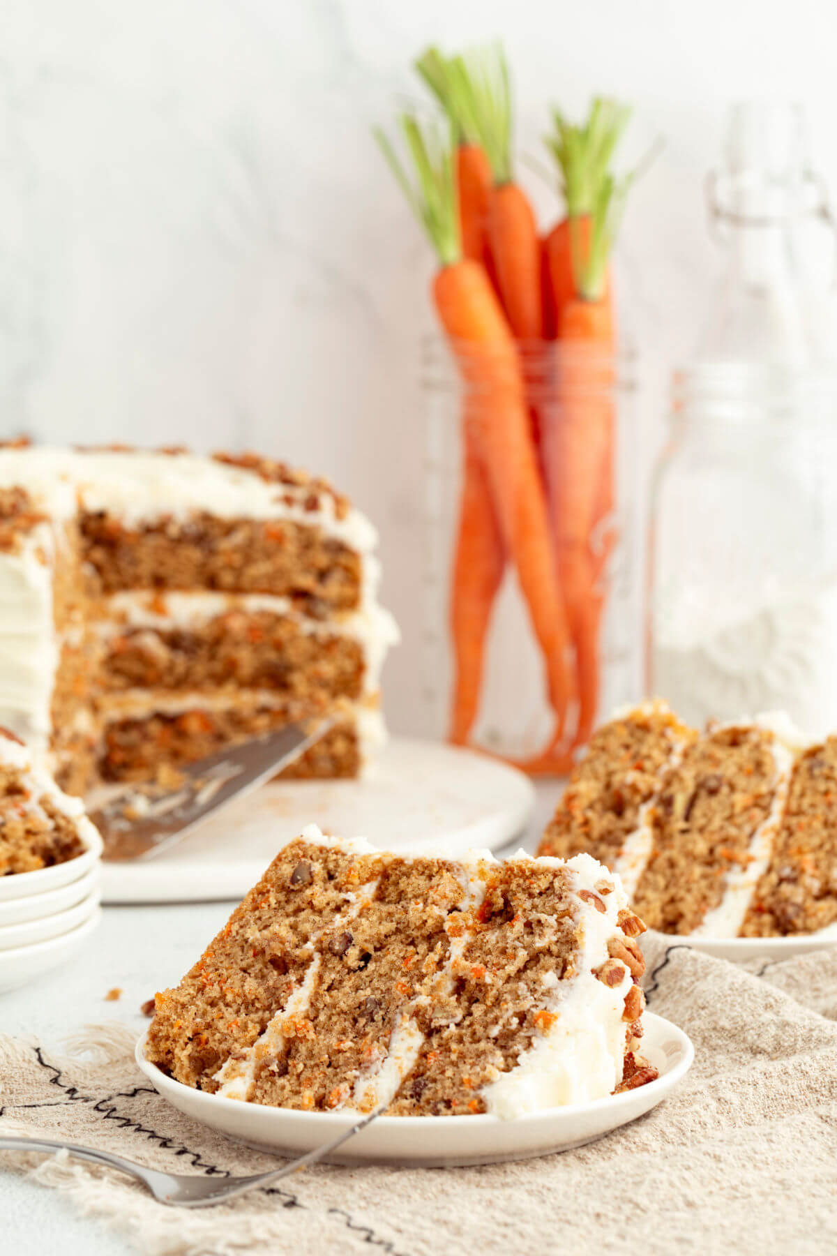 sourdough carrot cake with two slices cut out of it.