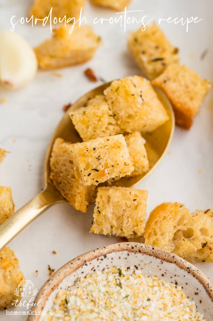 sourdough croutons on a gold spoon