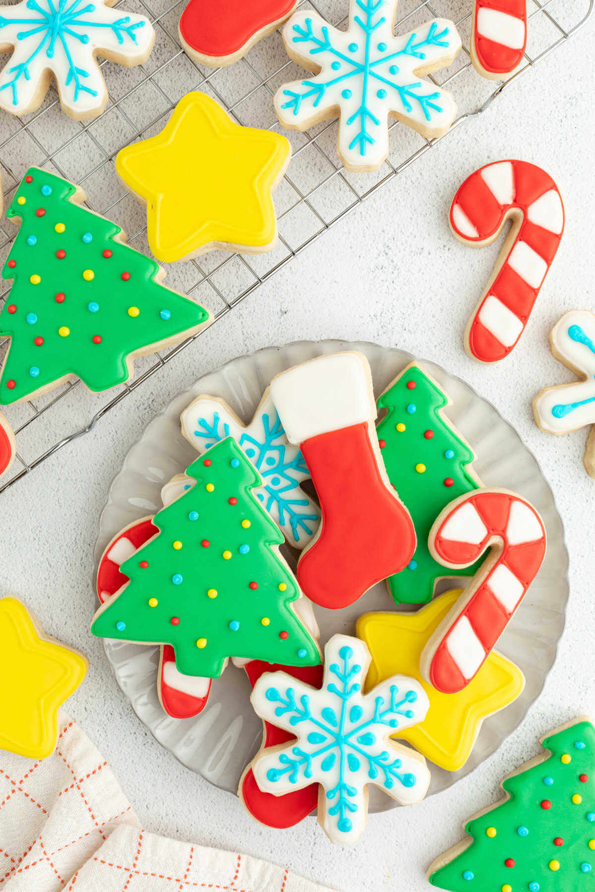 Sourdough cut out cookies on a plate after decorating with royal icing.