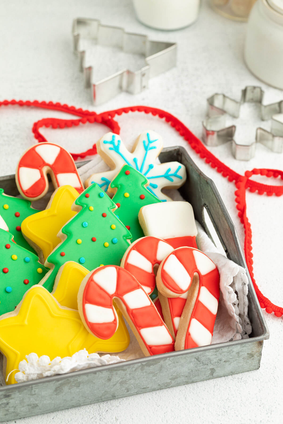 Frosted sourdough cut out cookies in a metal cookie tray.