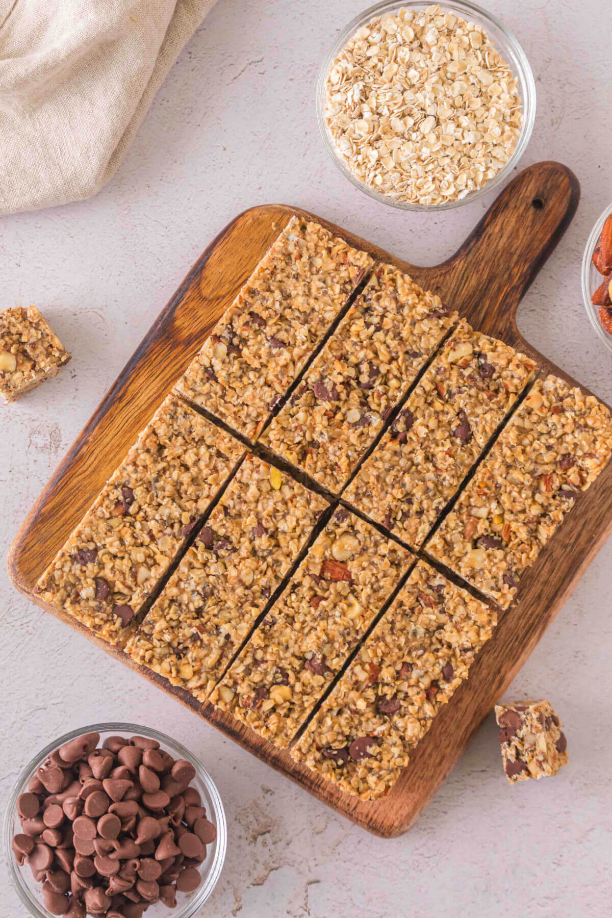 Sourdough granola bars cut into rectangles on a wood cutting board.
