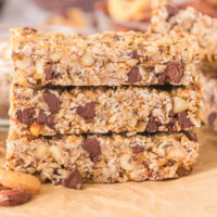 Three sourdough granola bars cut into rectangles on a piece of parchment paper.