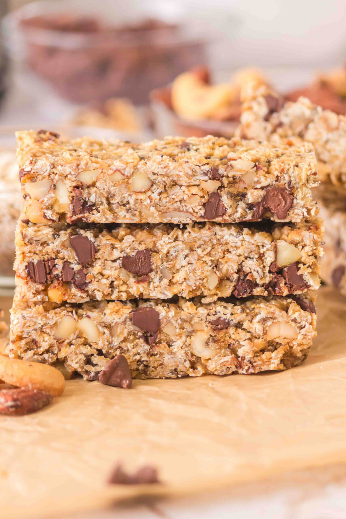 Three sourdough granola bars cut into rectangles on a piece of parchment paper.