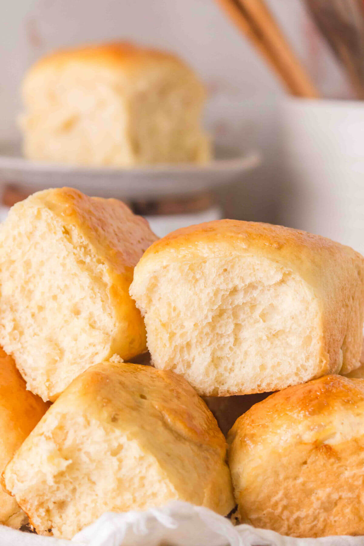 Sourdough discard rolls piled up in a bread basket for serving.