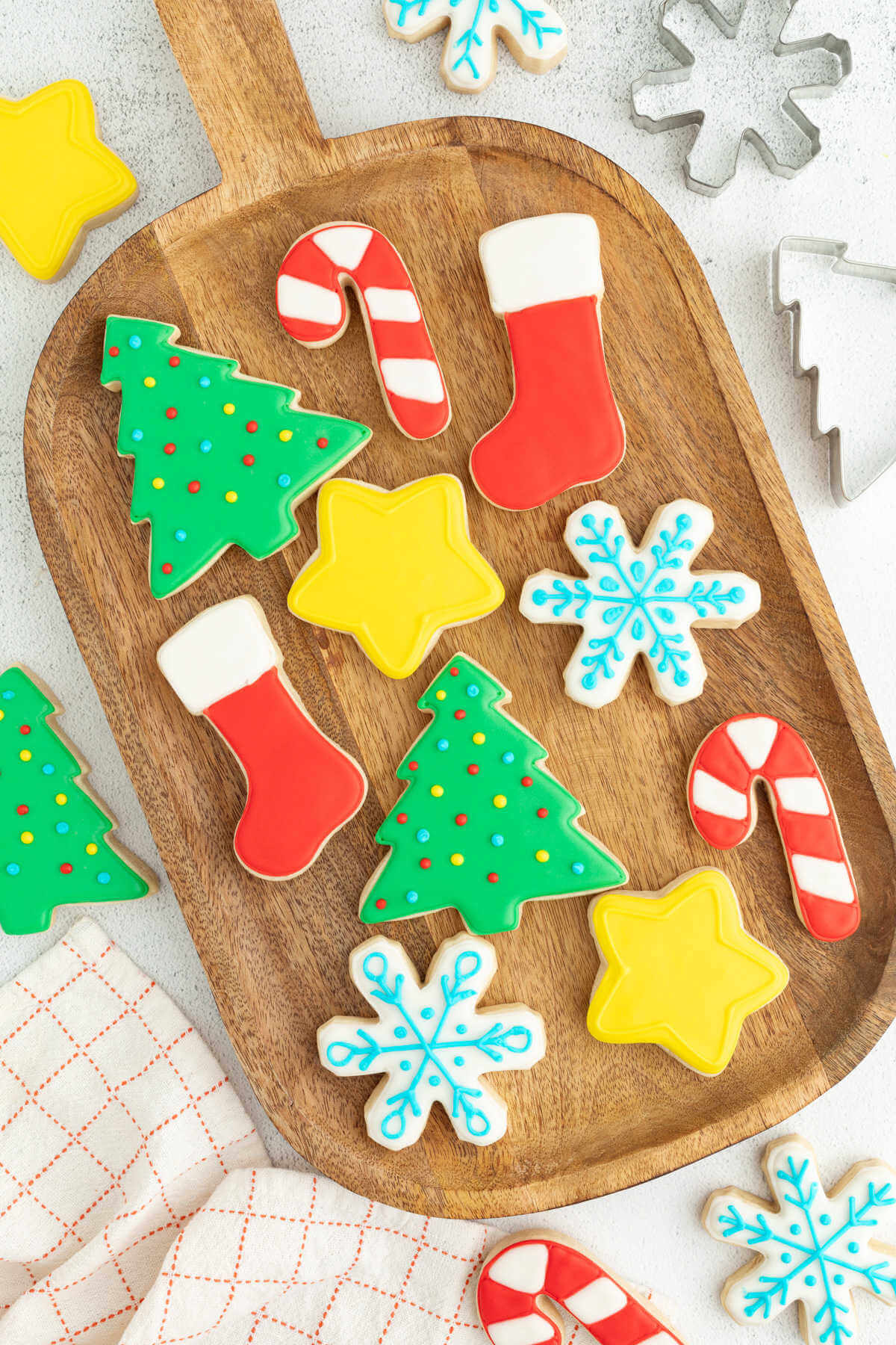 Sourdough cut out cookies on a wooden serving board.