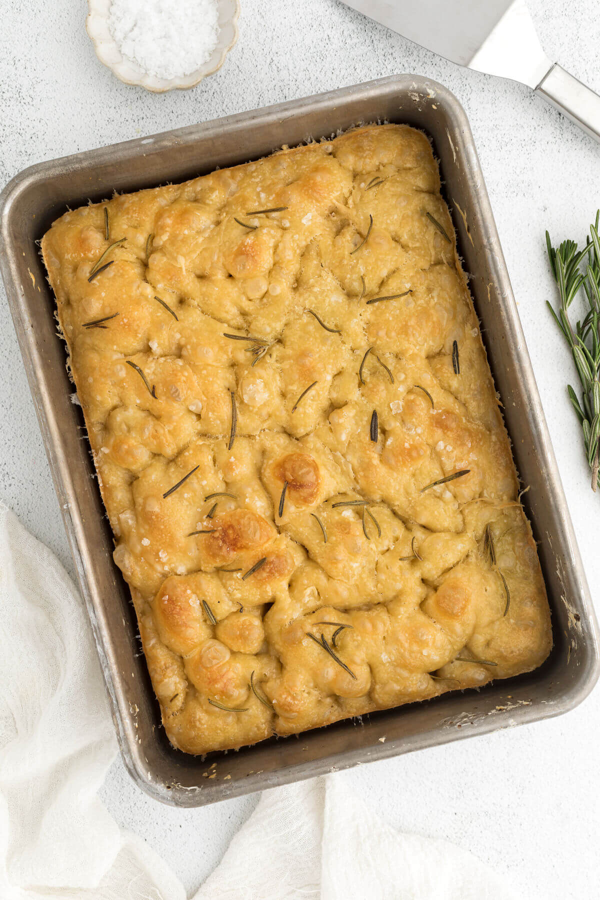 top down sourdough focaccia in metal pan