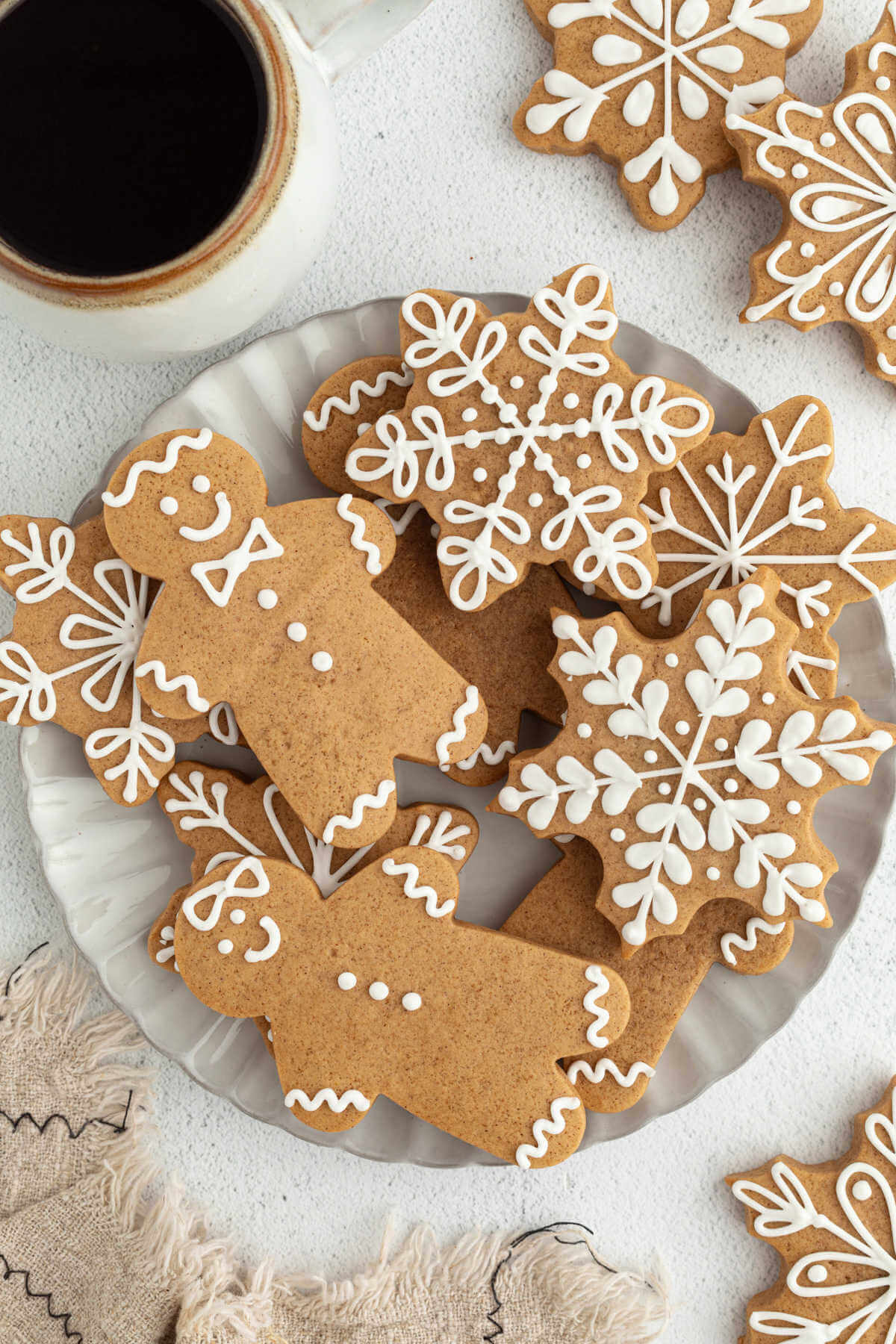 Decorated sourdough gingerbread cookies on a plate.