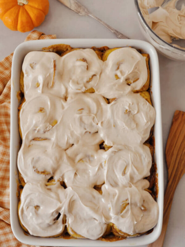 sourdough pumpkin cinnamon rolls in a baking dish.
