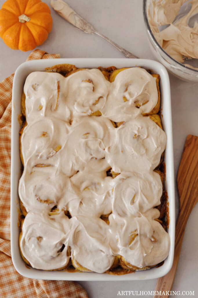 sourdough pumpkin cinnamon rolls in a baking dish.