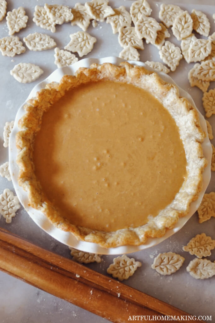 sourdough pumpkin pie crust with pumpkin filling and leaf cutouts around the pie