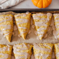 sourdough pumpkin scones on parchment paper on a baking sheet