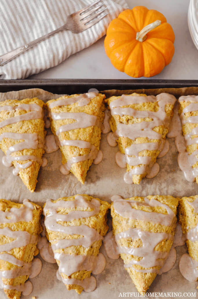 sourdough pumpkin scones on parchment paper on a baking sheet