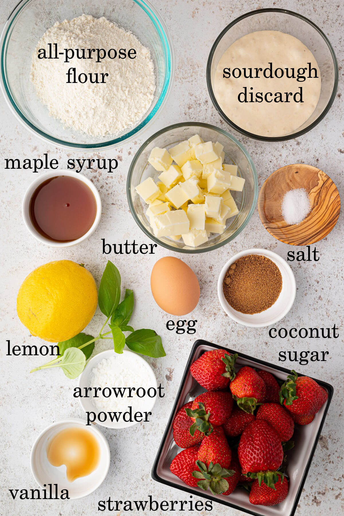 Ingredients in small bowls and containers with text overlay noting the name of each ingredient.
