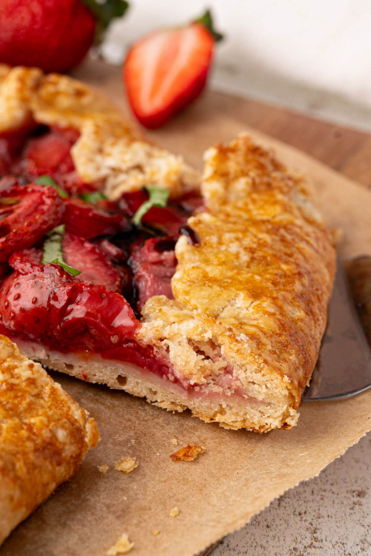 Baked sourdough galette cut into slices on a piece of parchment paper.