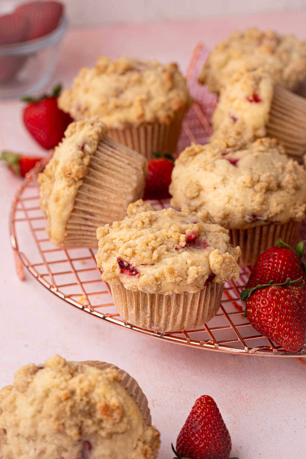 Sourdough strawberry muffins on a cooling rack.
