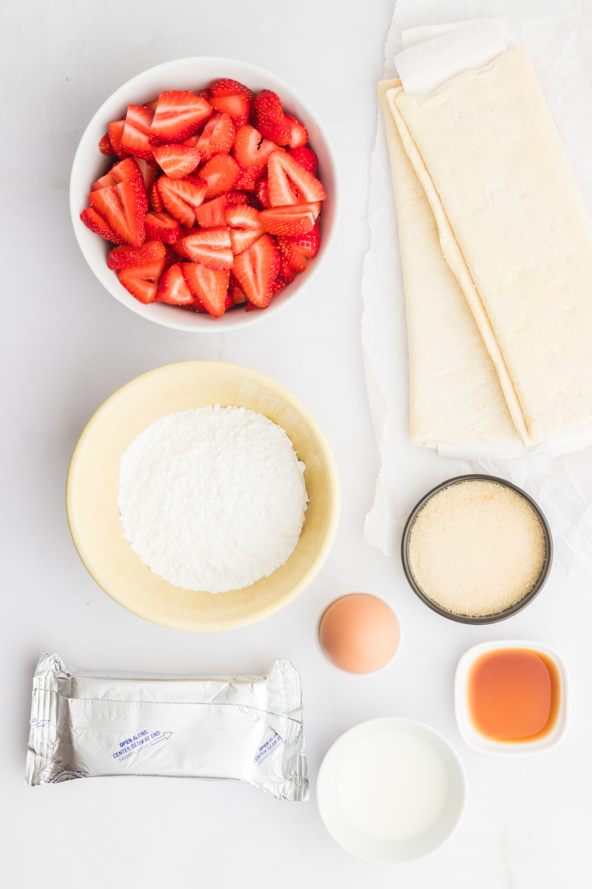 top down view of ingredients in small bowls on a white countertop