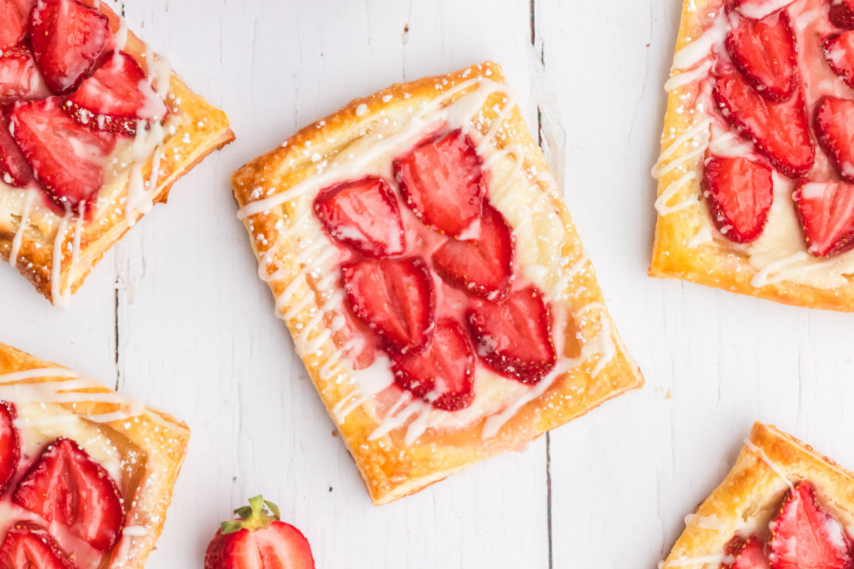 strawberry cream cheese danish on a white wood table